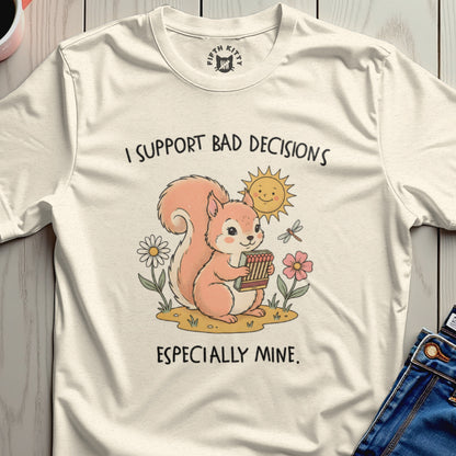 Squirrel holding matches with sun and flowers, text "I SUPPORT BAD DECISIONS ESPECIALLY MINE".