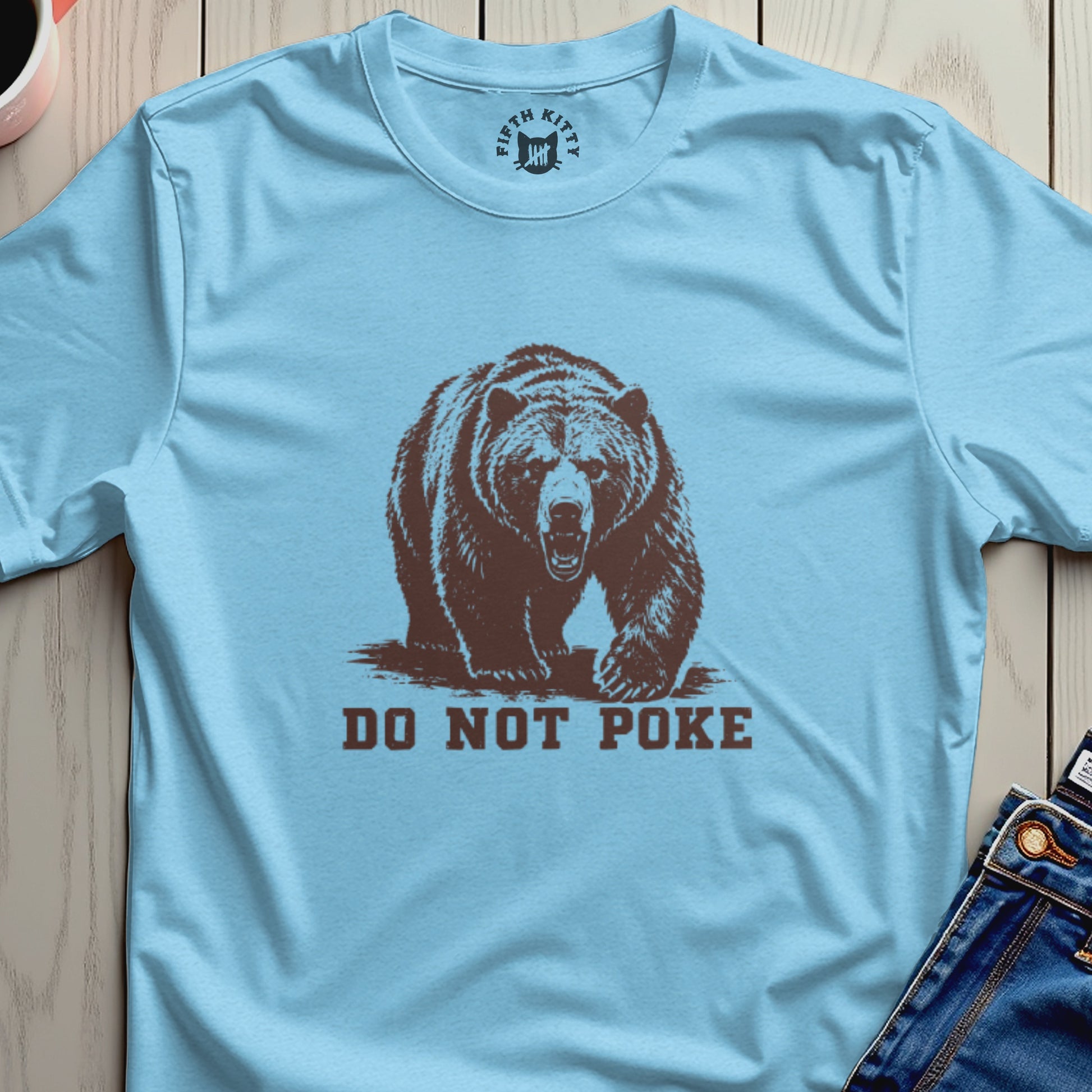 Light blue t-shirt with a brown bear graphic and "DO NOT POKE" text.