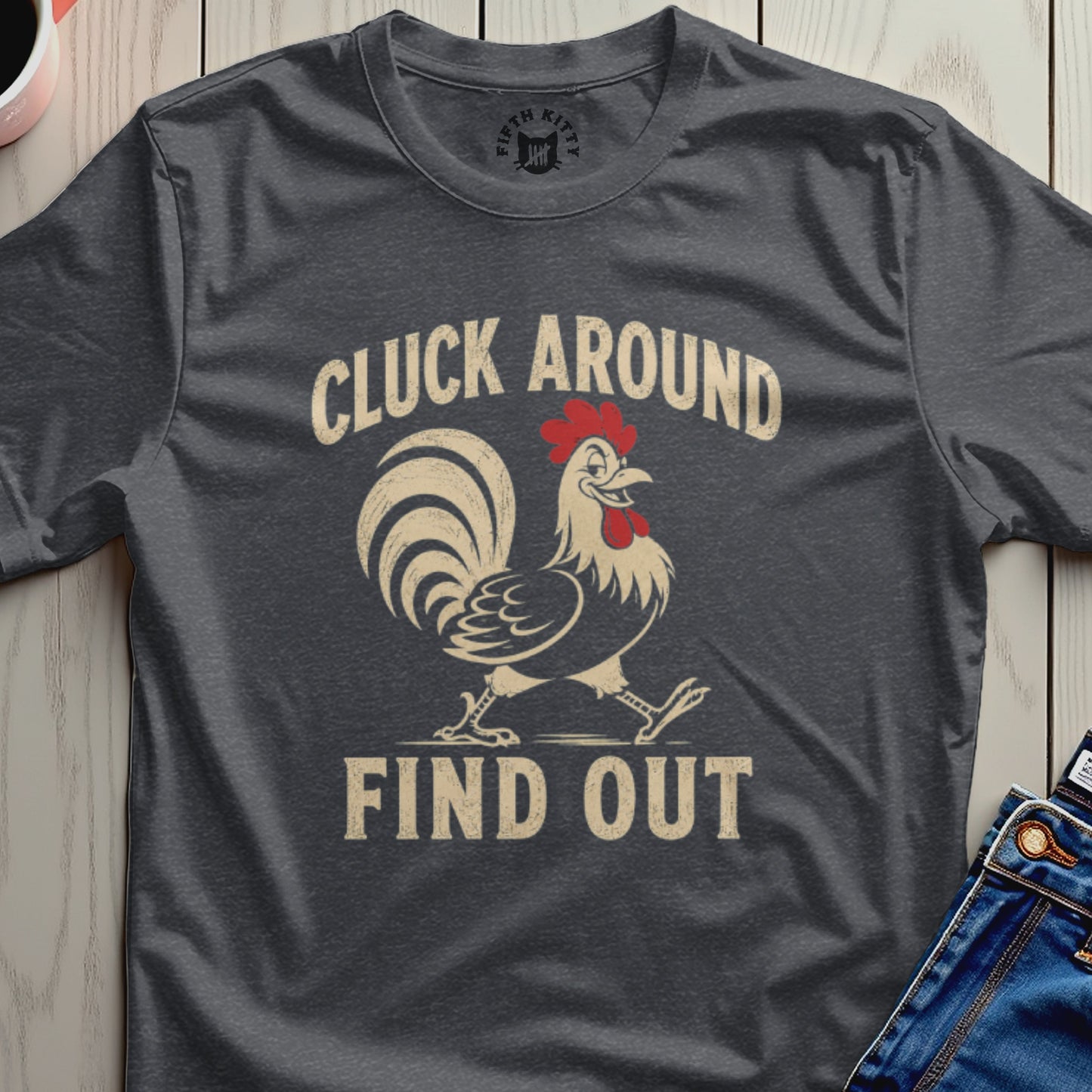 Dark t-shirt with a walking rooster graphic and text "CLUCK AROUND FIND OUT".