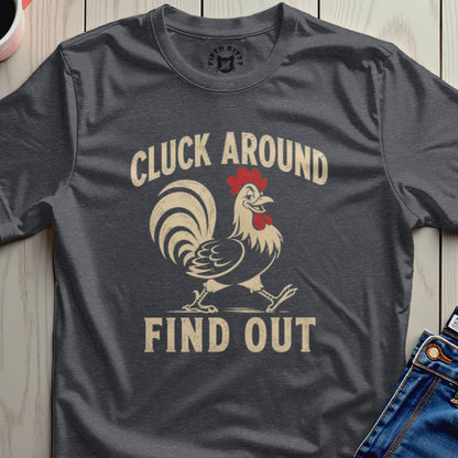 Dark t-shirt with a walking rooster graphic and text "CLUCK AROUND FIND OUT".