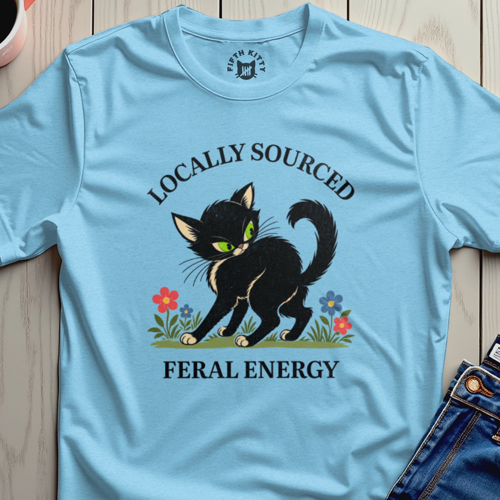 Black cat with green eyes and text "Locally Sourced Feral Energy".