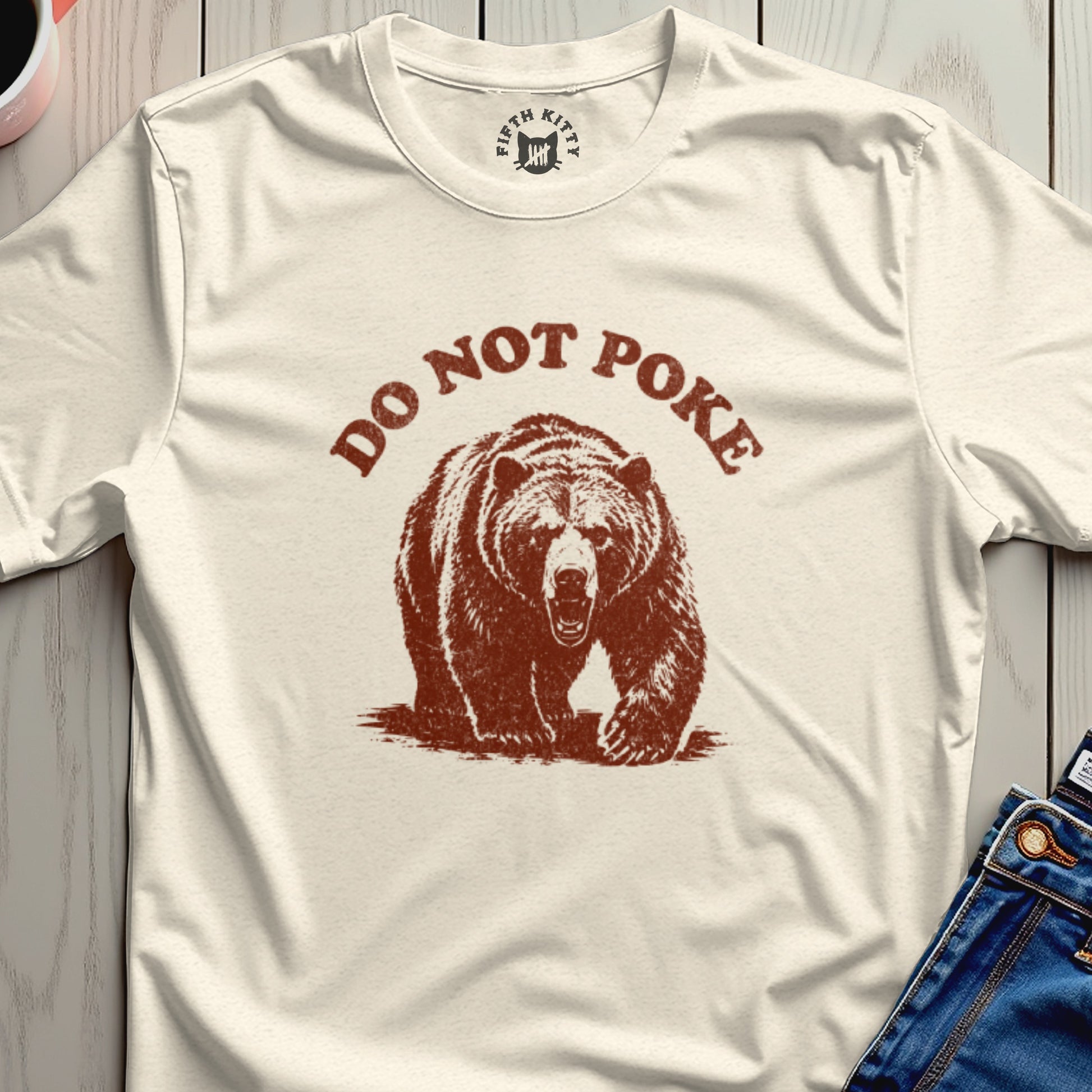 Cream t-shirt with distressed brown bear graphic and text "DO NOT POKE".