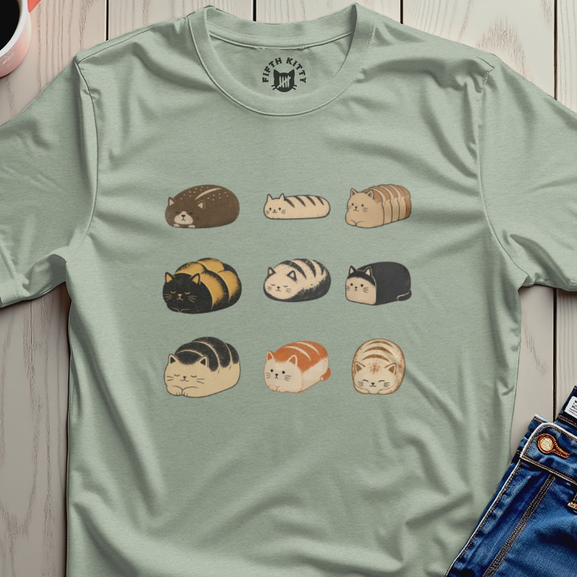 T-shirt with a repeating pattern of cartoon cats resembling loaves of bread.