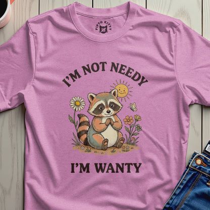 Pink t-shirt with raccoon and sun graphic, "I'm Not Needy I'm Wanty" text.