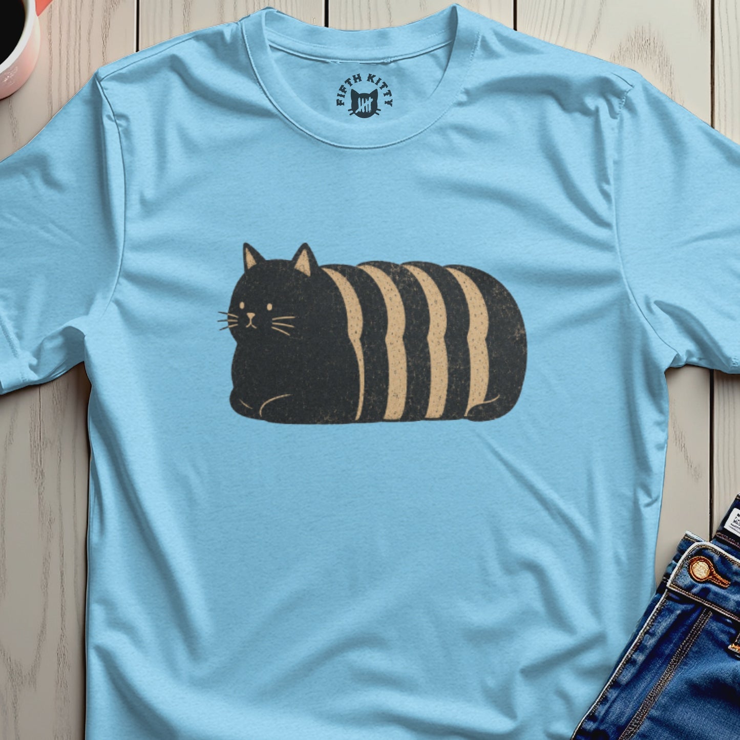 Light blue t-shirt with a black and tan striped loaf cat graphic and Fifth Kitty logo.