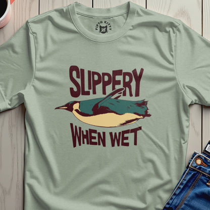 Green t-shirt with a penguin and "Slippery When Wet" text.