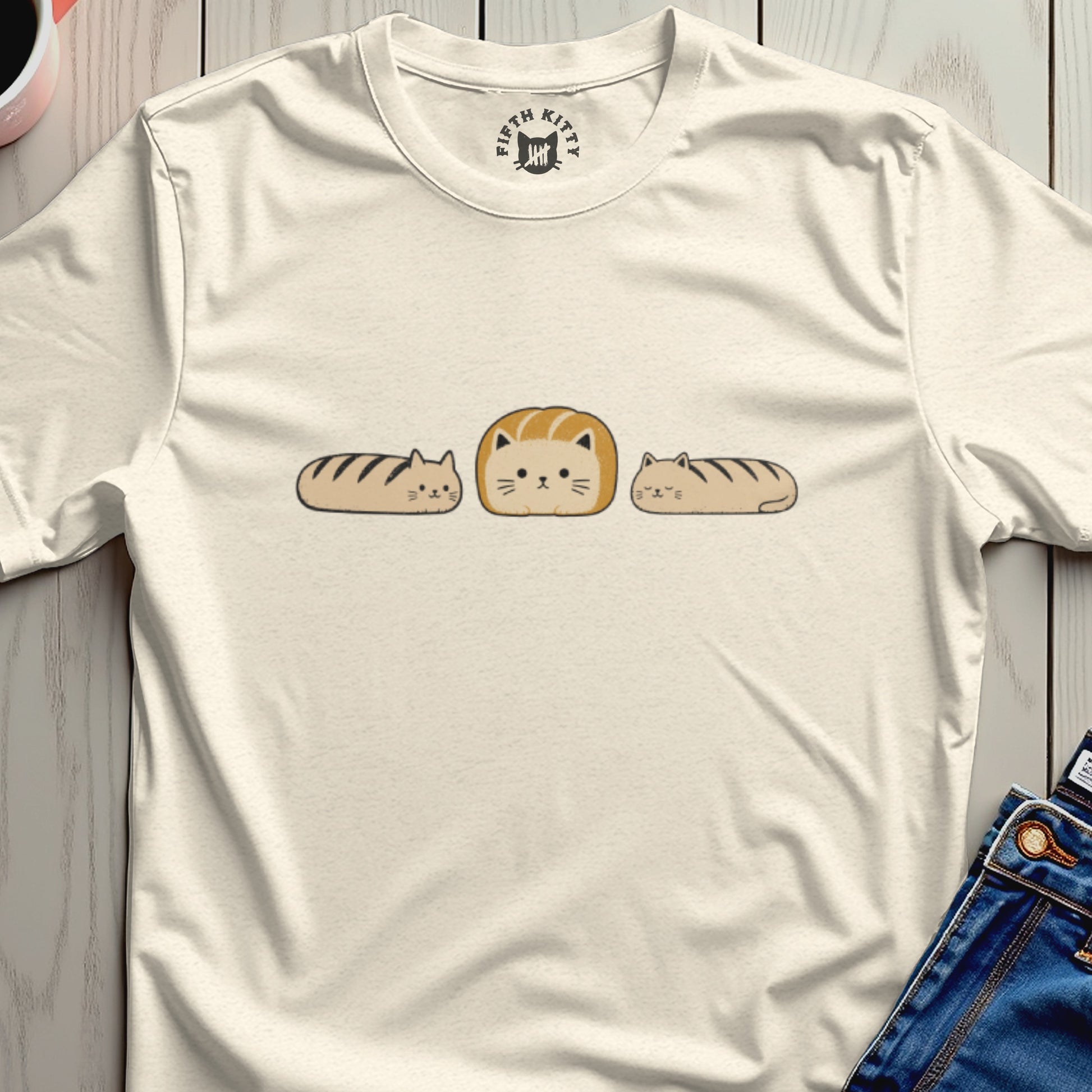 Cream t-shirt featuring three loaf-shaped cats with stripes and the Fifth Kitty logo on the neck.