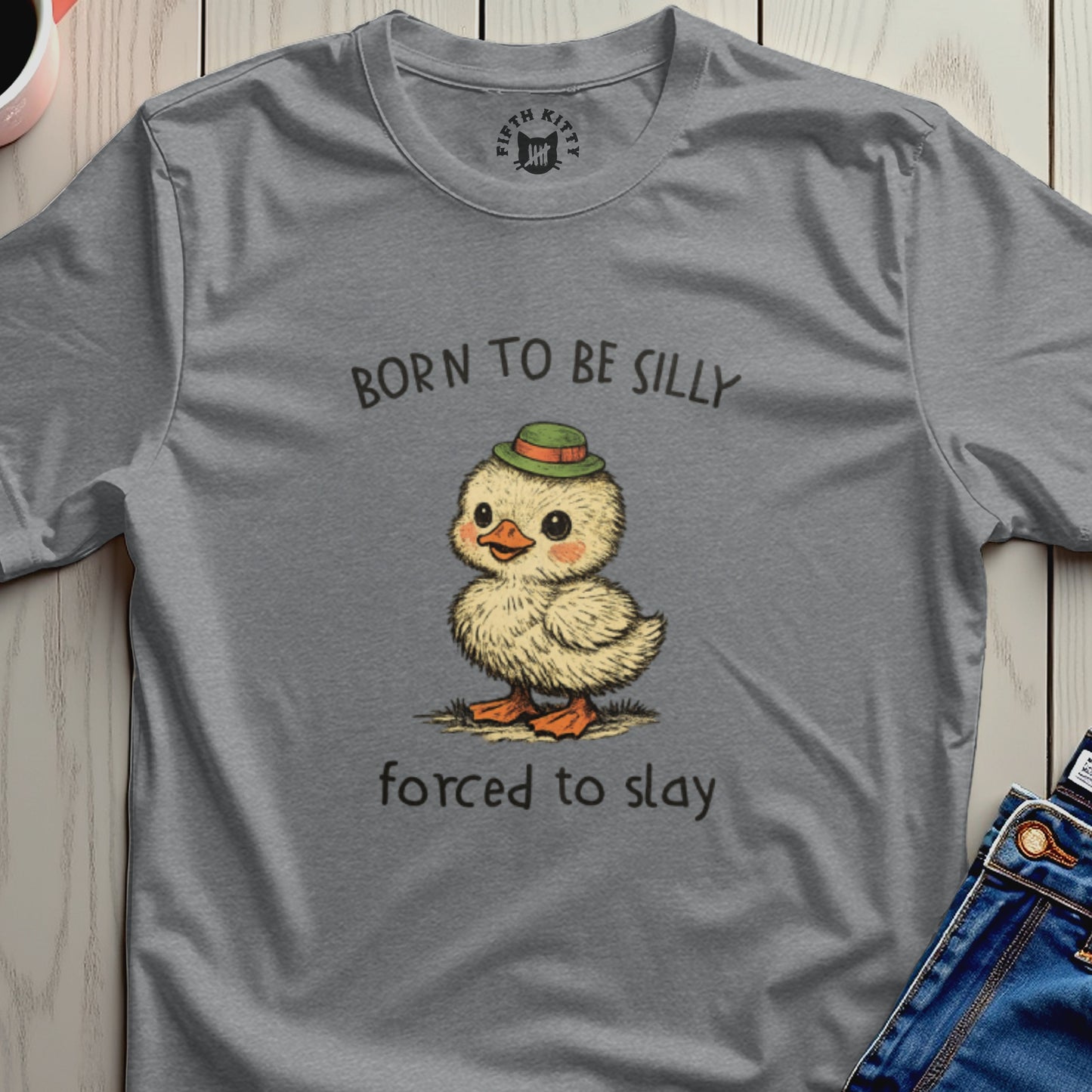 Gray t-shirt with a cartoon duckling in a hat and text "BORN TO BE SILLY FORCED TO SLAY".