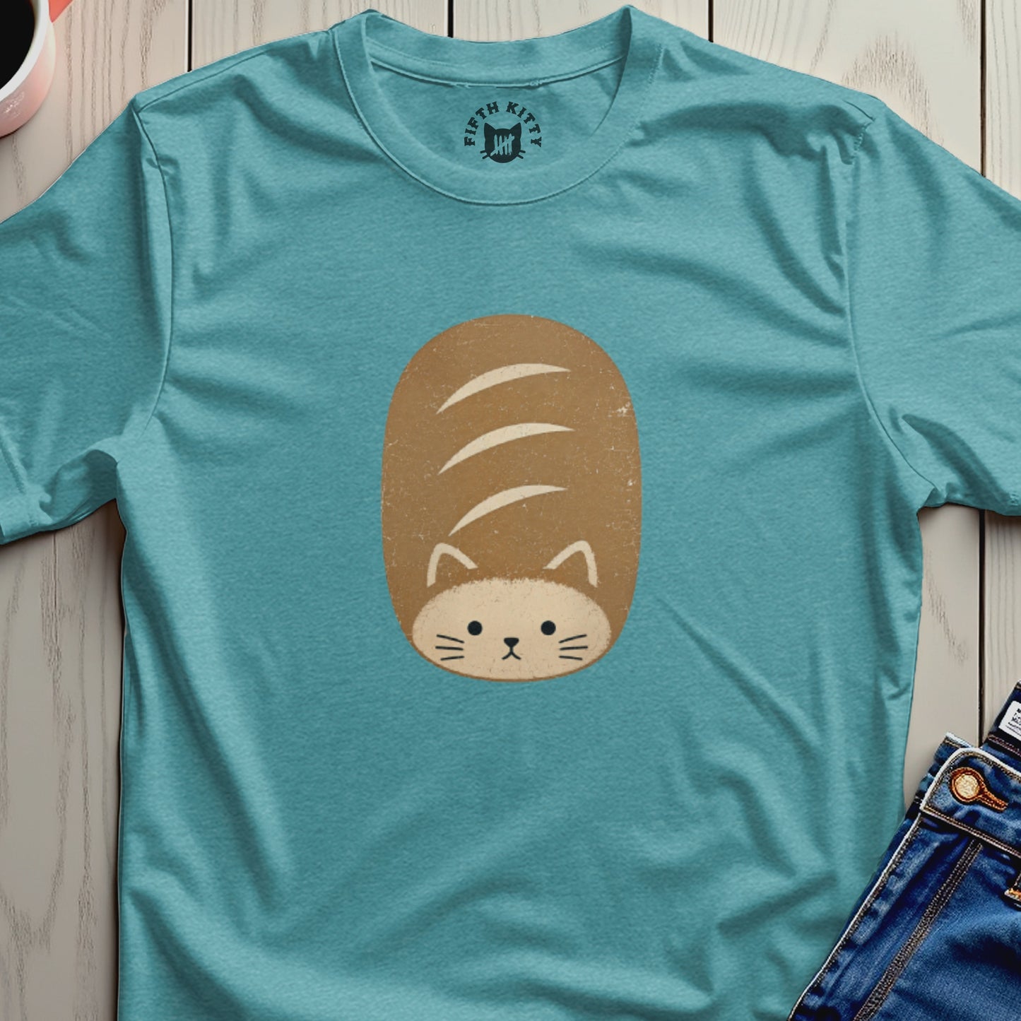Teal t-shirt with a loaf of bread shaped cat graphic and Fifth Kitty logo.