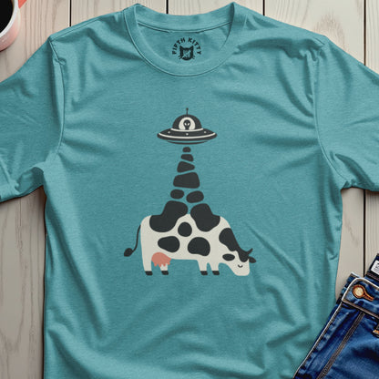 Teal t-shirt with a graphic of a cow being abducted by a UFO.