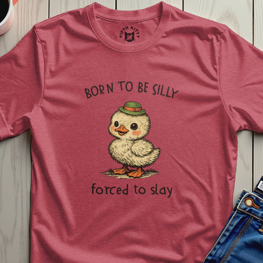 T-shirt with a duckling wearing a green hat and text "Born to be silly, forced to slay."