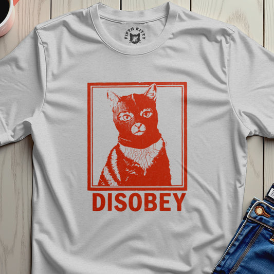White t-shirt with a red graphic of a cat wearing a ski mask and the word "DISOBEY".