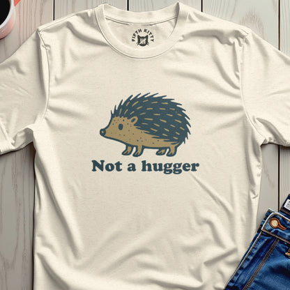 Cream t-shirt with a cartoon hedgehog graphic and "Not a hugger" text.