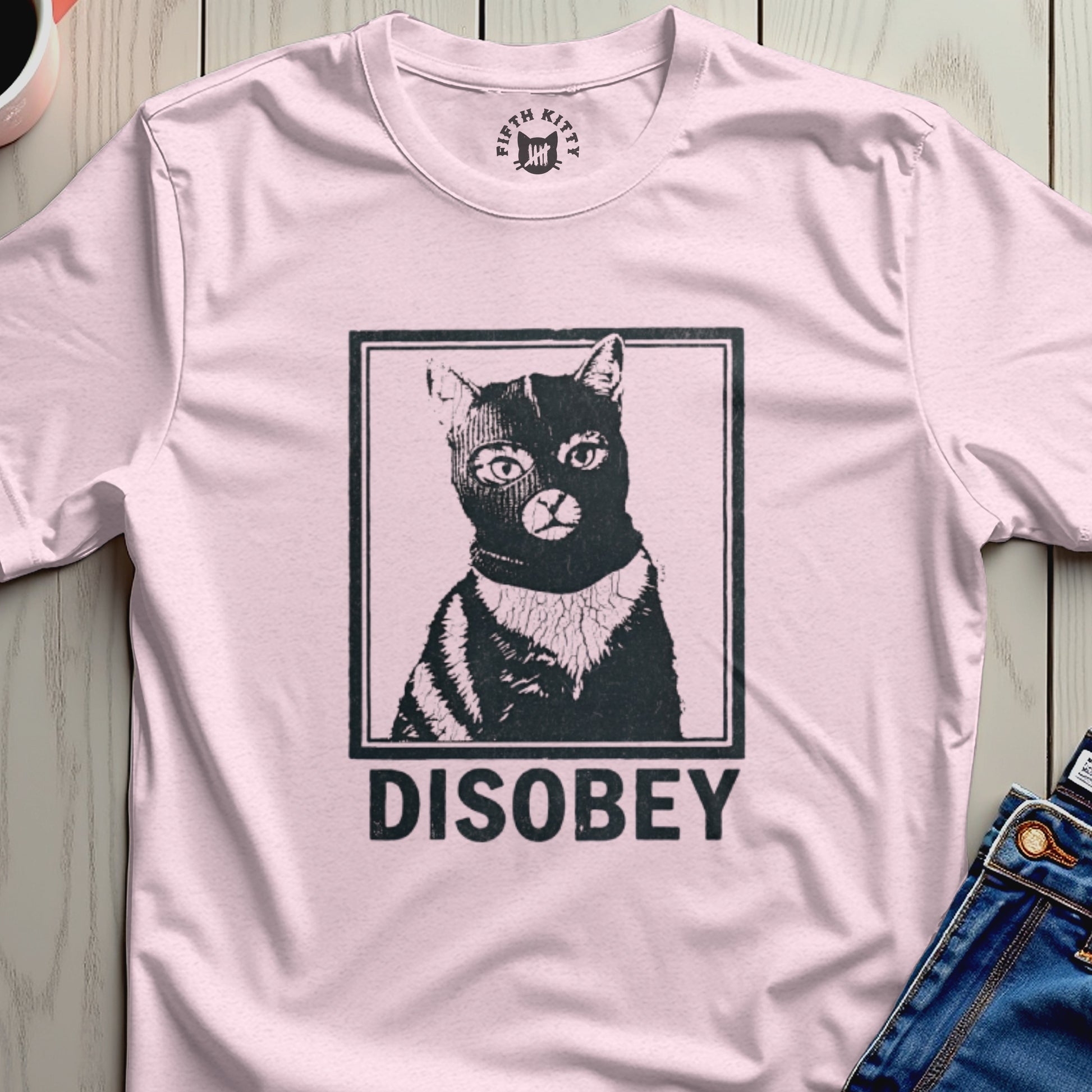 Black cat wearing a ski mask and "DISOBEY" text on a pink t-shirt.