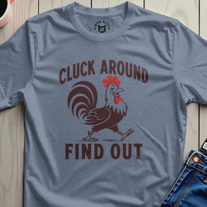 Blue t-shirt with a walking rooster graphic and text "CLUCK AROUND FIND OUT".