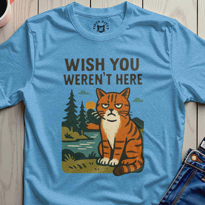Blue t-shirt with graphic of grumpy cat sitting by a lake, trees, and sun; text reads "WISH YOU WEREN'T HERE".