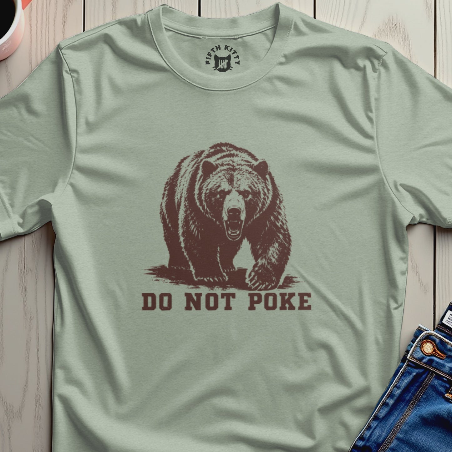 Bear illustration with "DO NOT POKE" text on a light green t-shirt.