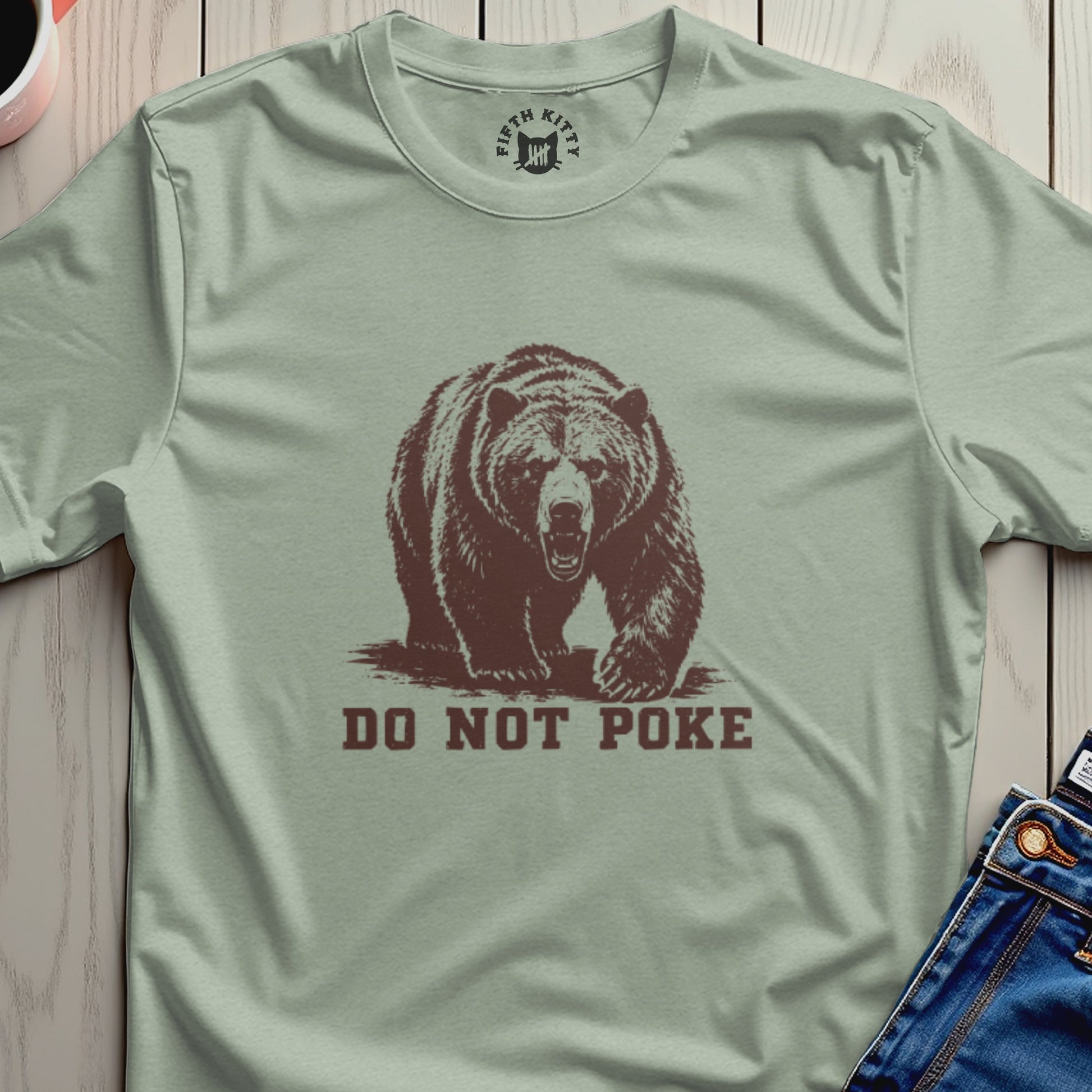 Bear illustration with "DO NOT POKE" text on a light green t-shirt.
