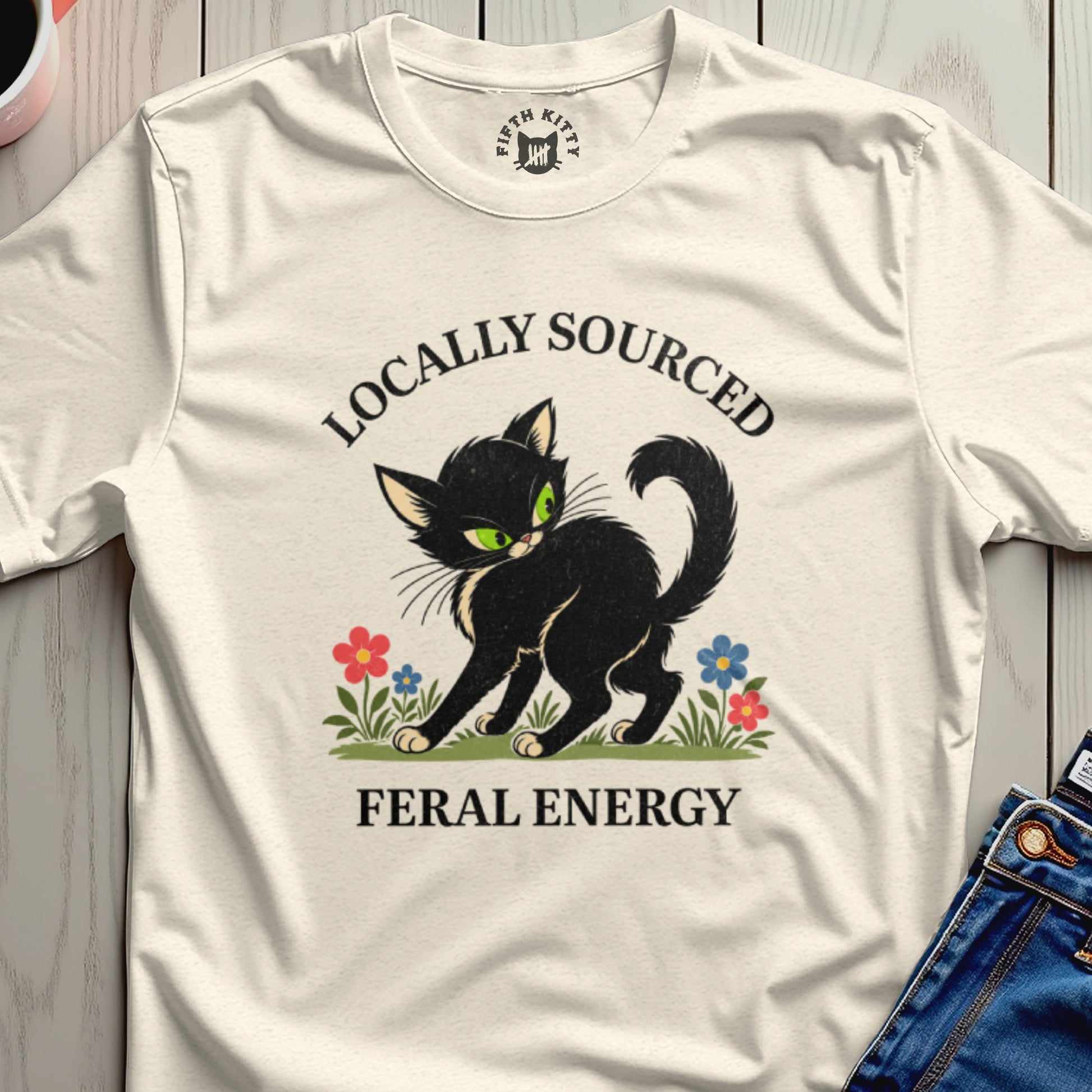 Black cat with green eyes, flowers, and text "Locally Sourced Feral Energy".