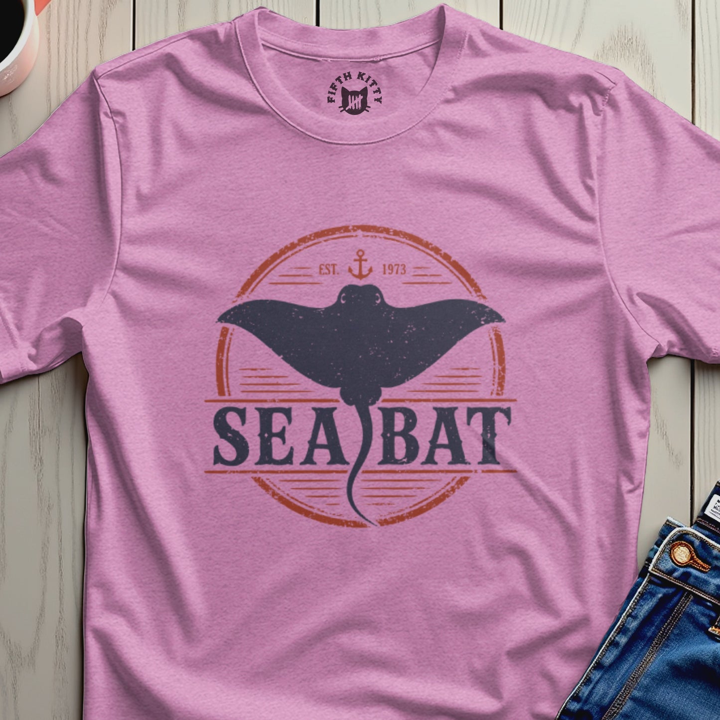 Pink t-shirt with a dark grey sea bat graphic and "SEA BAT EST. 1973" text.