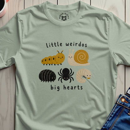 T-shirt with "Little weirdos big hearts" text and cute illustrations of insects.