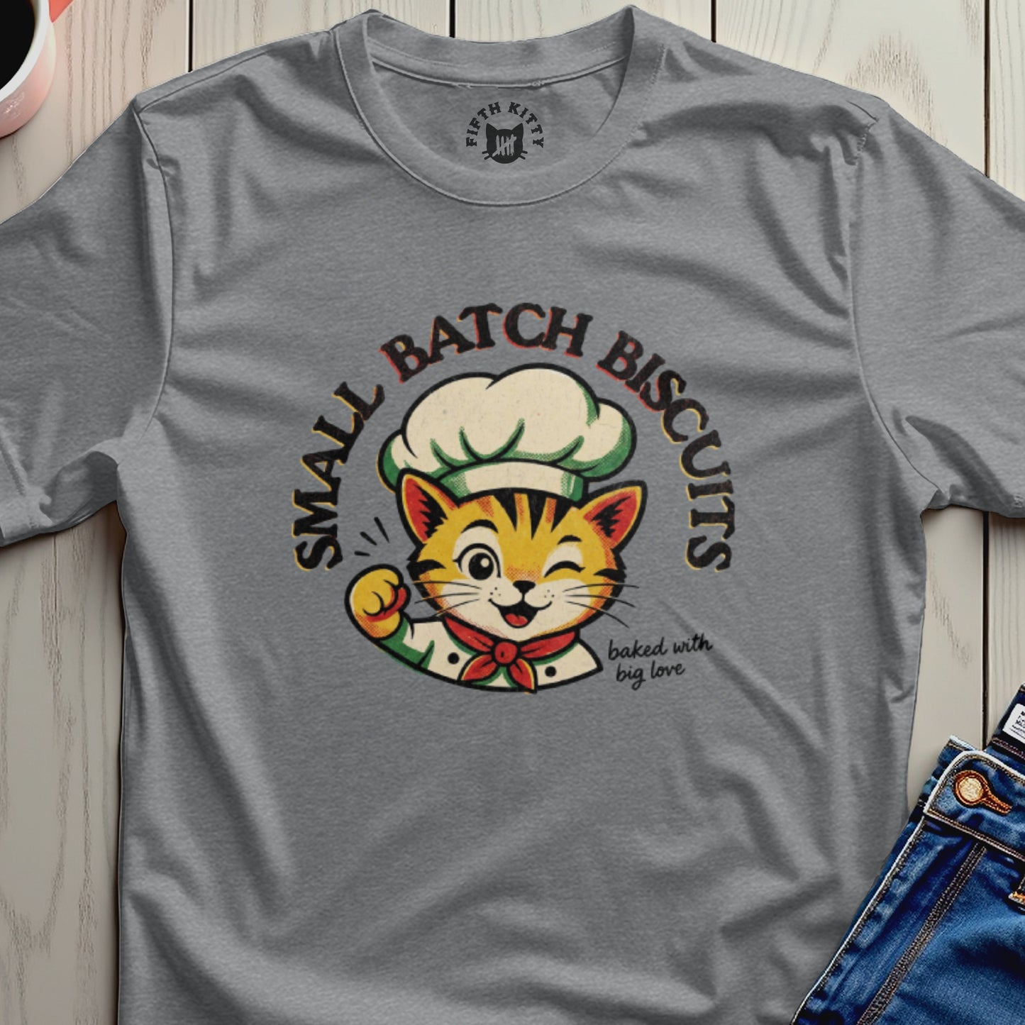 Gray t-shirt with cartoon cat chef wearing a chef hat and bib, saying "Small Batch Biscuits" and "baked with big love."