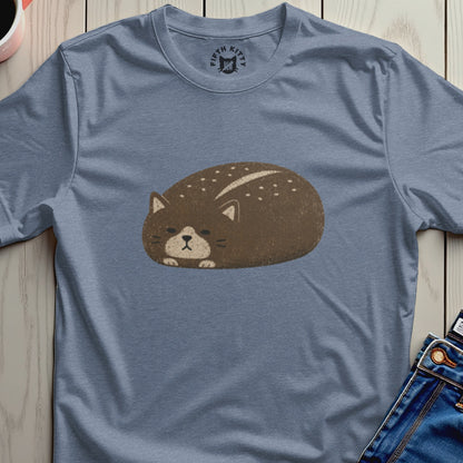 Brown cat loaf illustration with white dots on a blue t-shirt.