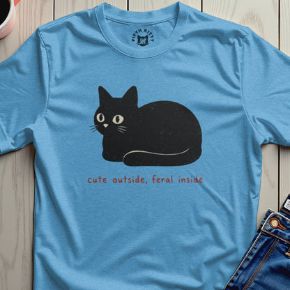 Blue t-shirt with a black cat graphic and text "cute outside, feral inside".