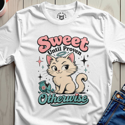 Cream cat with halo sits next to broken vase illustration with text "Sweet Until Proven Otherwise".