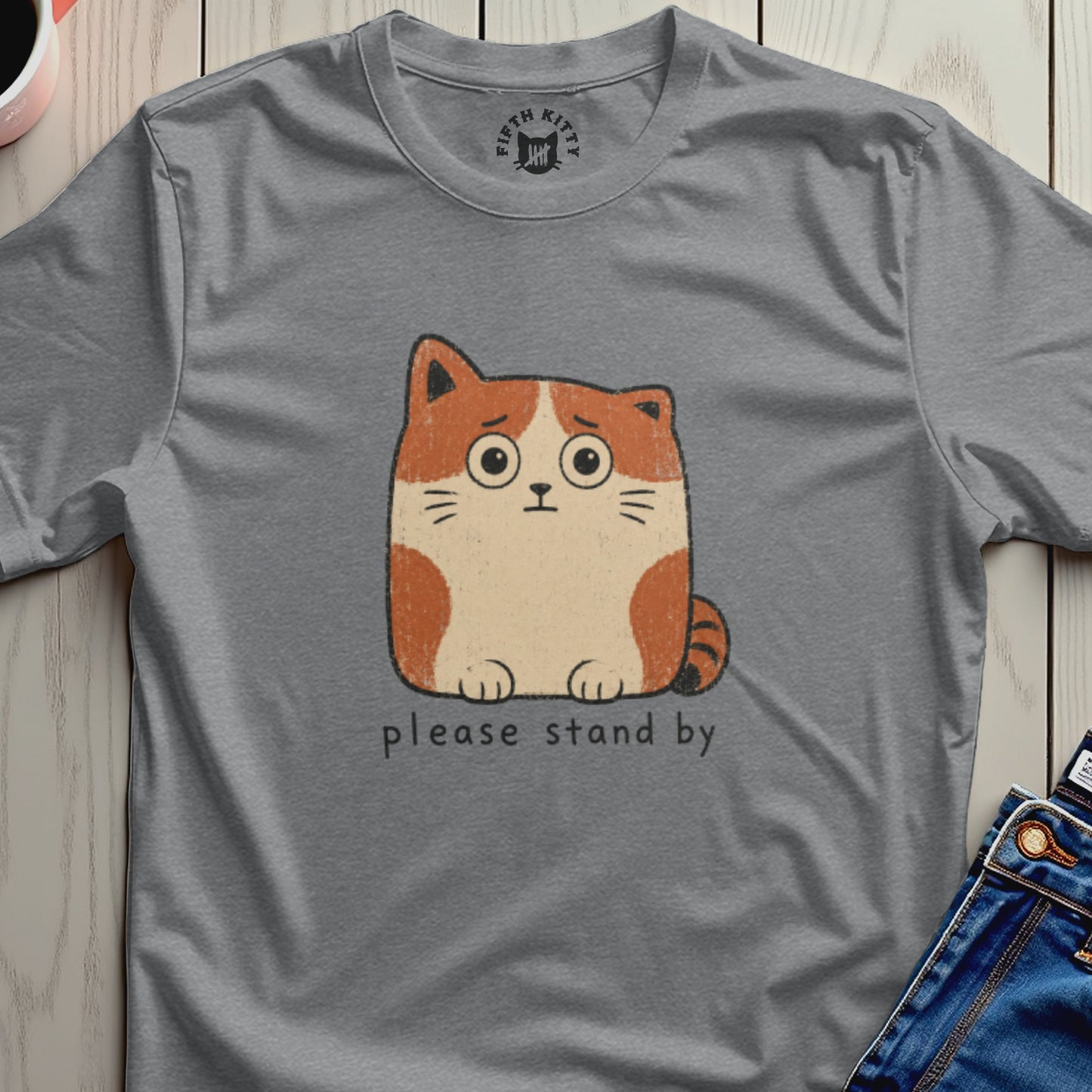 Grey t-shirt with a cartoon cat and text "please stand by"