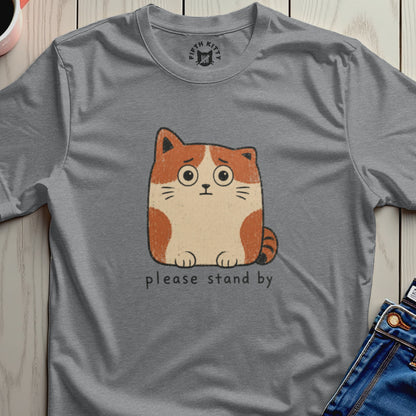 Grey t-shirt with a cartoon cat and text "please stand by"