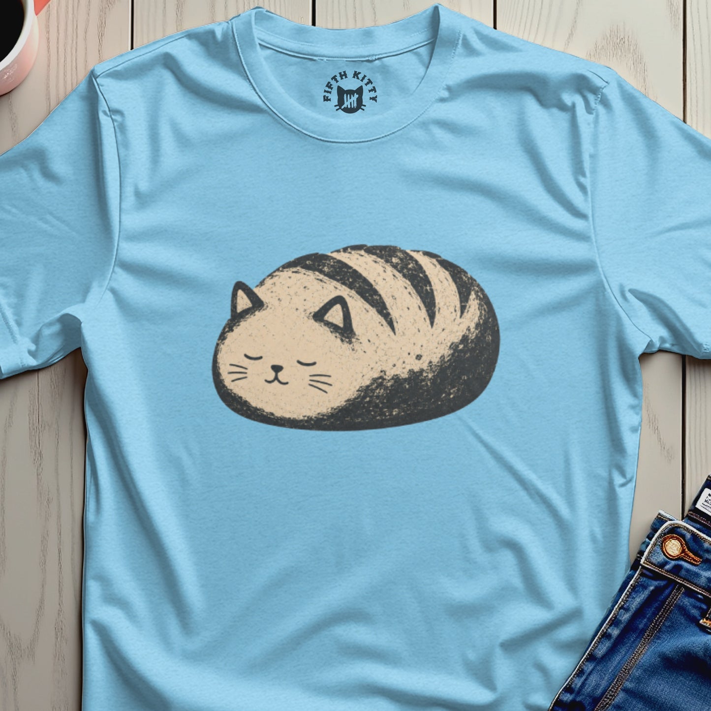 Light blue t-shirt with a cartoon cat bread loaf graphic and "Fifth Kitty" logo.
