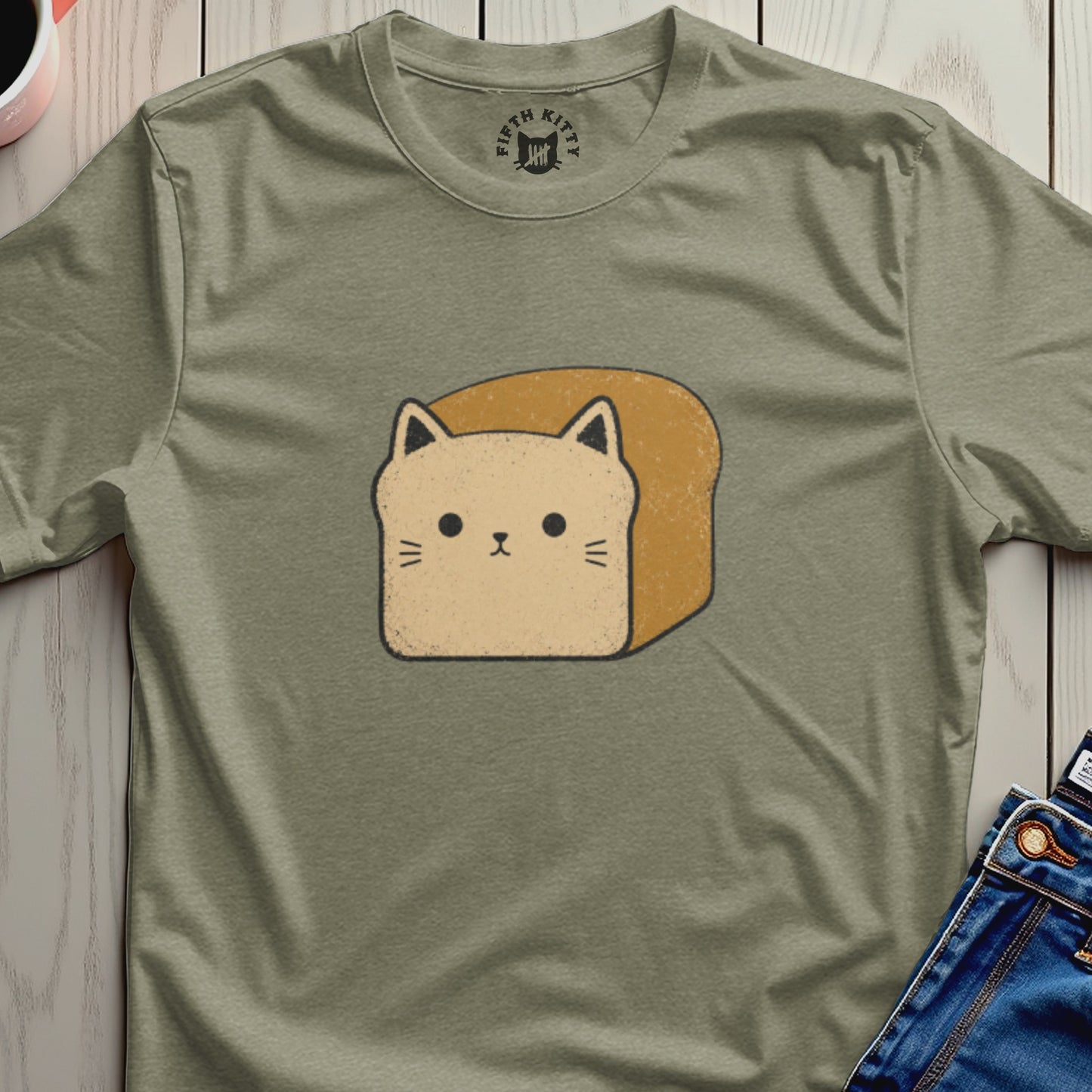 Cartoon loaf of bread with cat face and ears on olive green t-shirt.