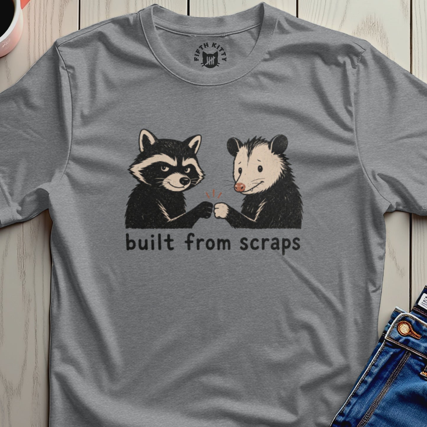 Raccoon and possum fist-bumping with text "built from scraps".