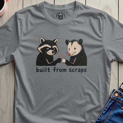 Raccoon and possum fist-bumping with text "built from scraps".