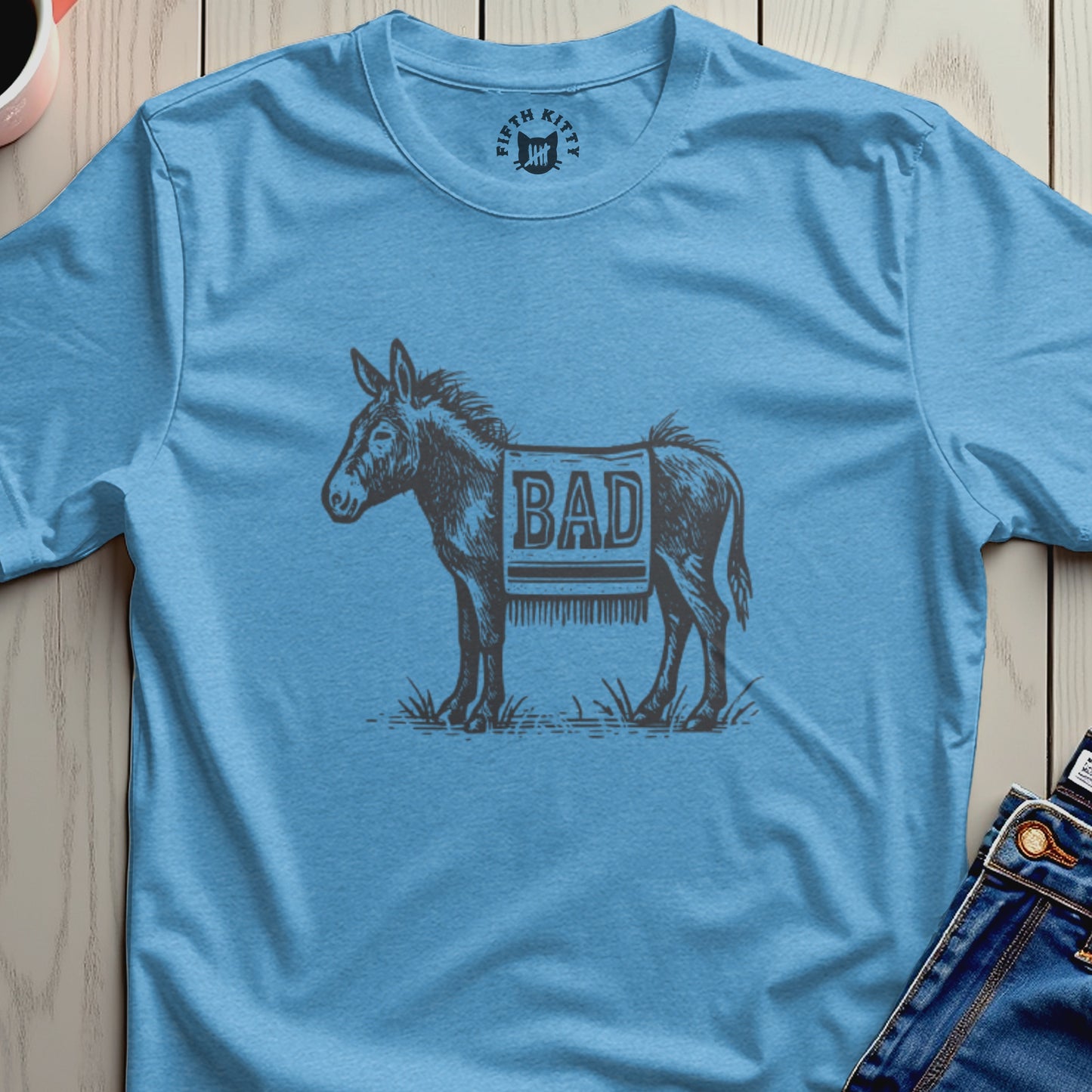 Blue t-shirt with a donkey graphic and the word "BAD" printed on its saddle blanket.