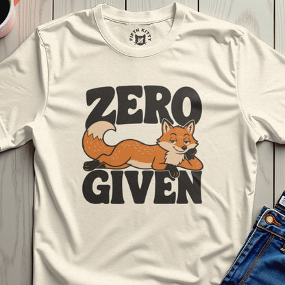 Cream t-shirt with "ZERO GIVEN" text and a relaxed fox illustration.