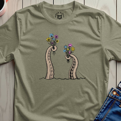 Two octopus tentacles emerge from water, holding bouquets of colorful flowers.