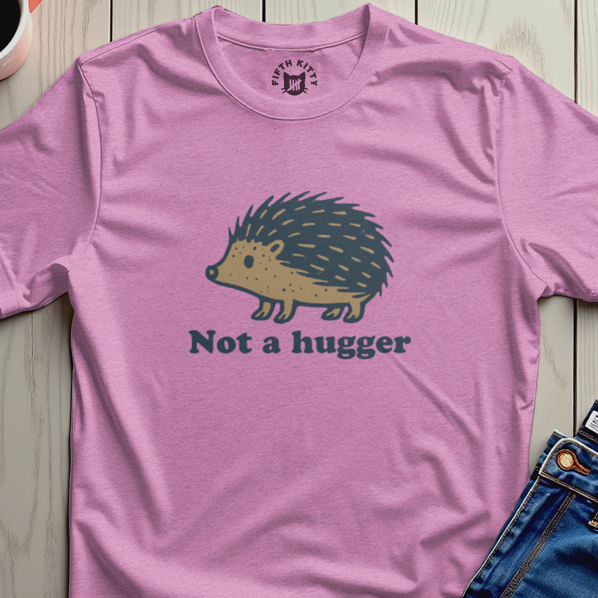 Pink t-shirt with a hedgehog graphic and the text "Not a hugger".