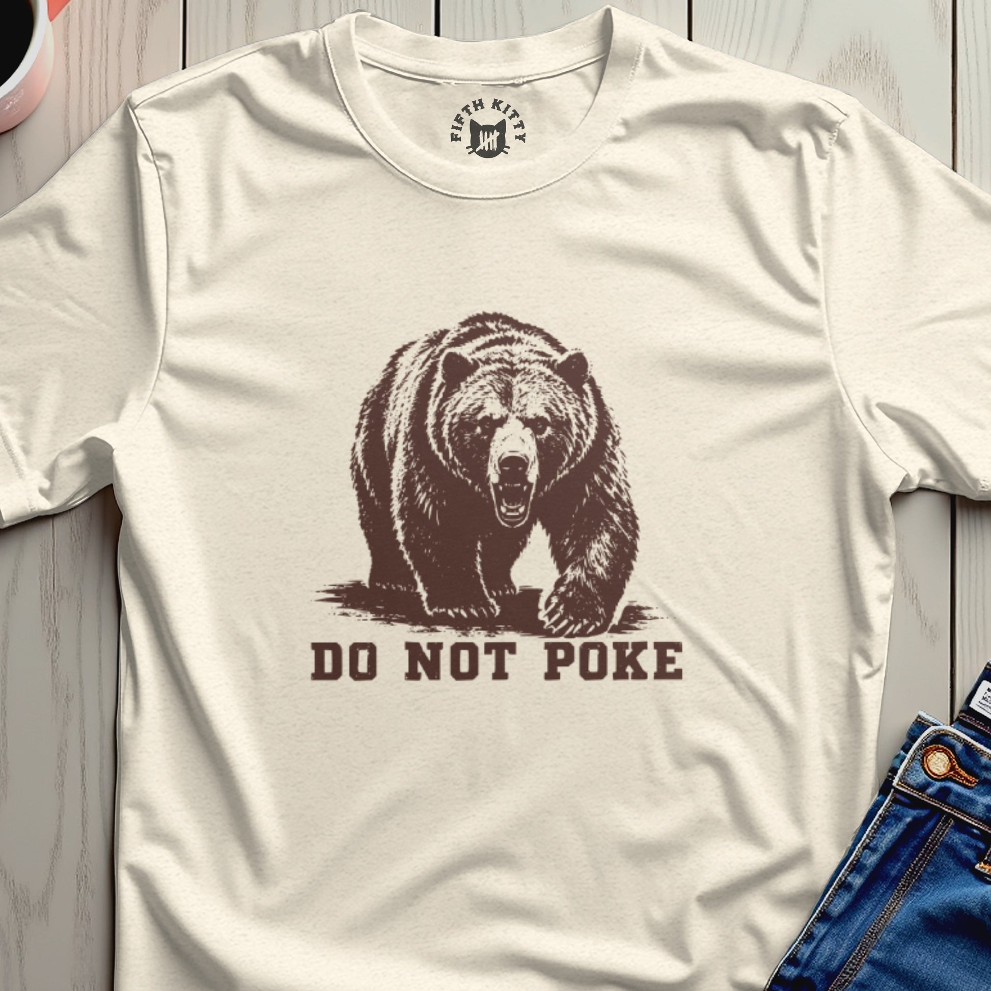 Cream t-shirt with brown bear graphic and text "DO NOT POKE".