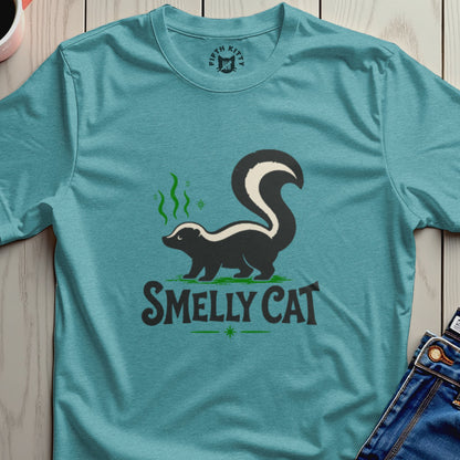 Teal t-shirt with a skunk graphic and the text "SMELLY CAT".