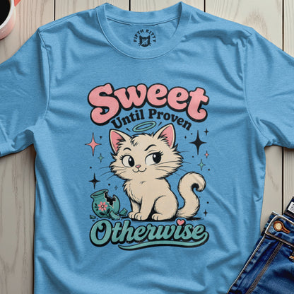 Blue t-shirt with "Sweet Until Proven Otherwise" text and cartoon cat with broken vase.