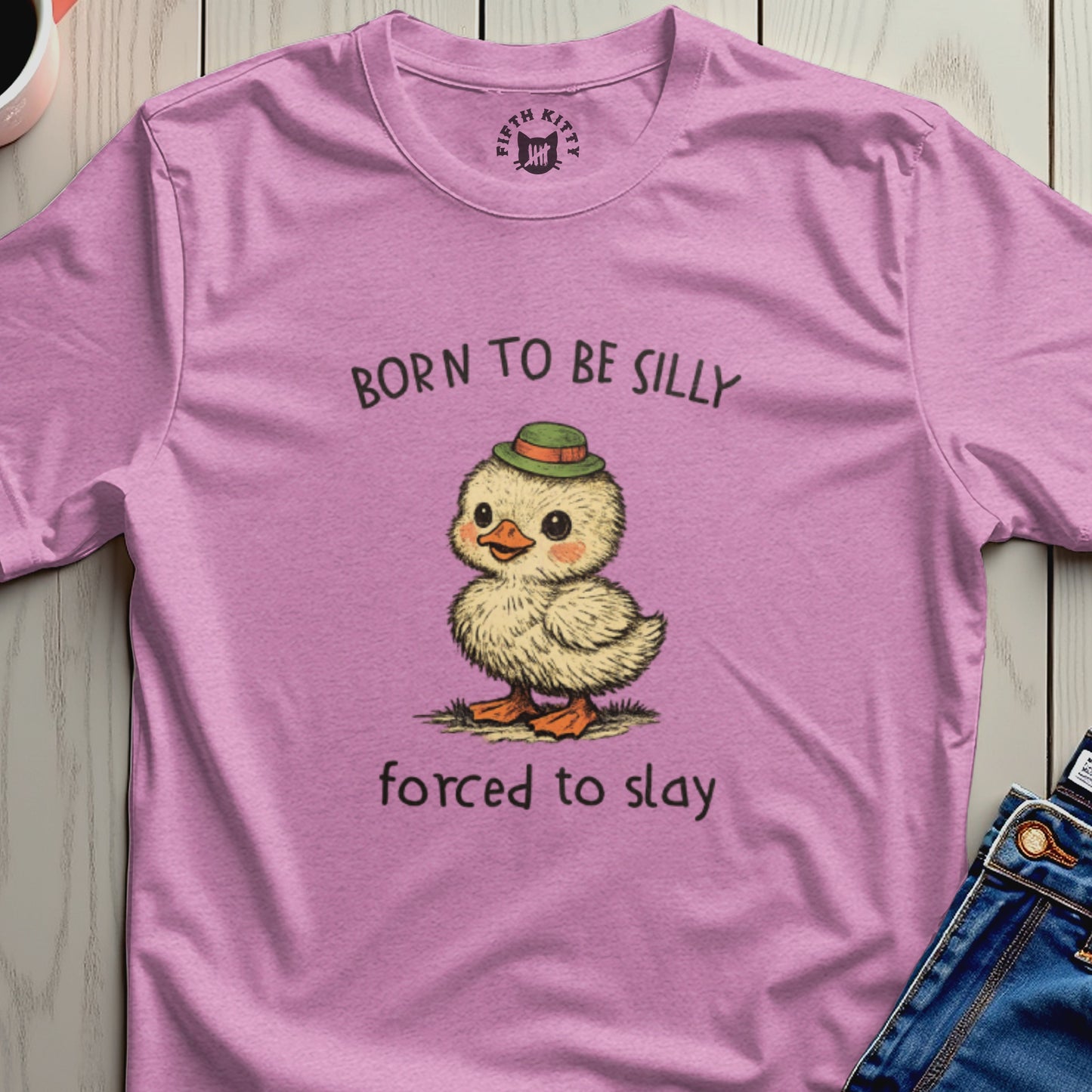 Pink t-shirt with cartoon duckling wearing a hat and text "BORN TO BE SILLY forced to slay".