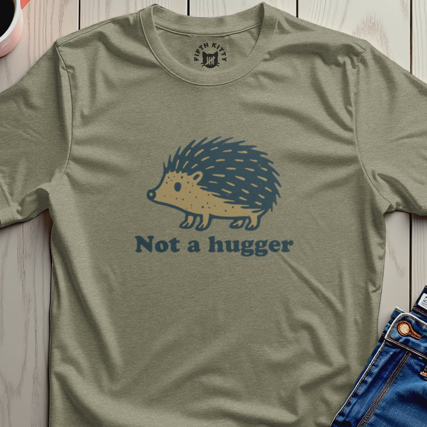 Olive green t-shirt with a blue hedgehog graphic and text "Not a hugger".