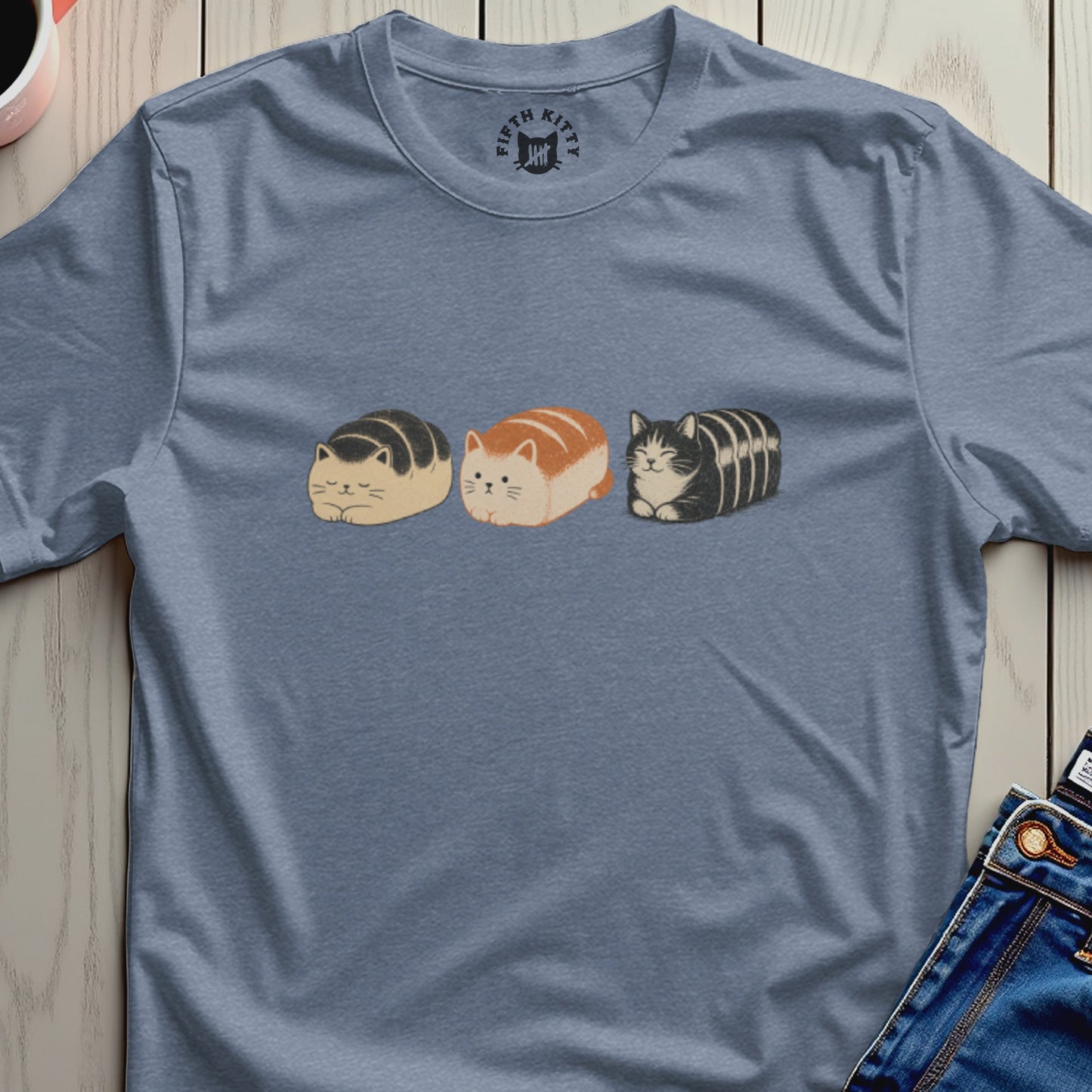 Three loaf-shaped cats with ears and whiskers, in black, orange, and tabby patterns.