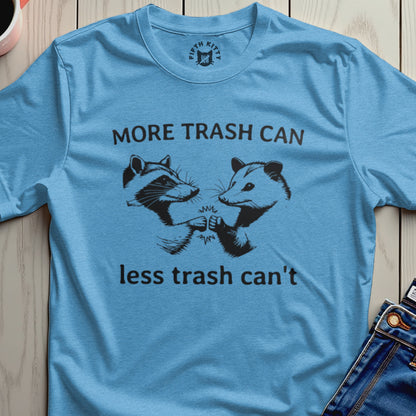 Blue t-shirt with raccoon and opossum fist bumping and text "MORE TRASH CAN" and "less trash can't".
