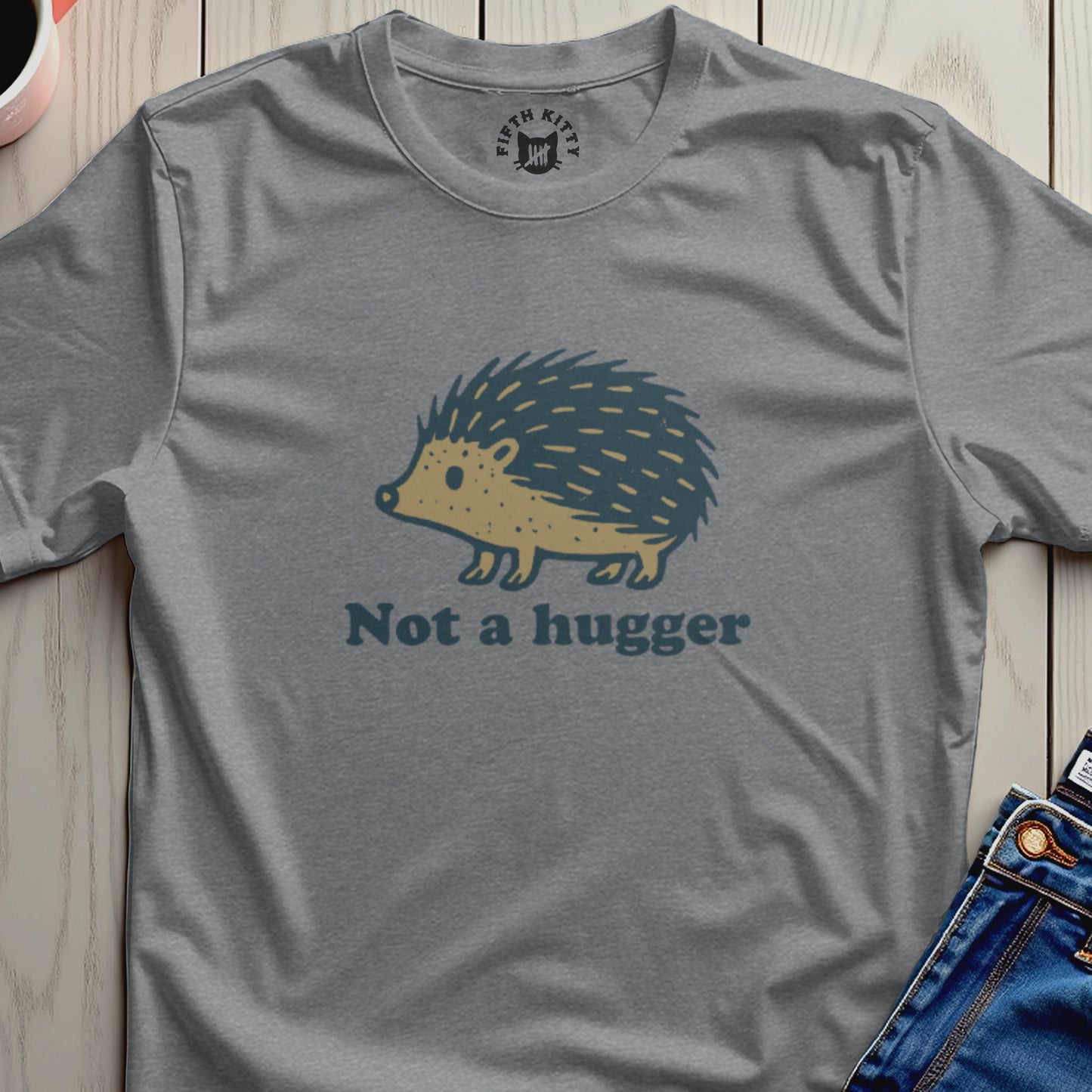 Gray t-shirt with a cartoon hedgehog graphic and "Not a hugger" text.