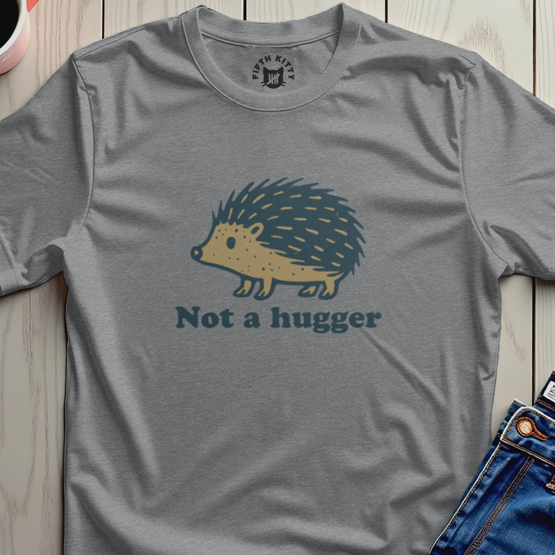 Gray t-shirt with a cartoon hedgehog graphic and "Not a hugger" text.