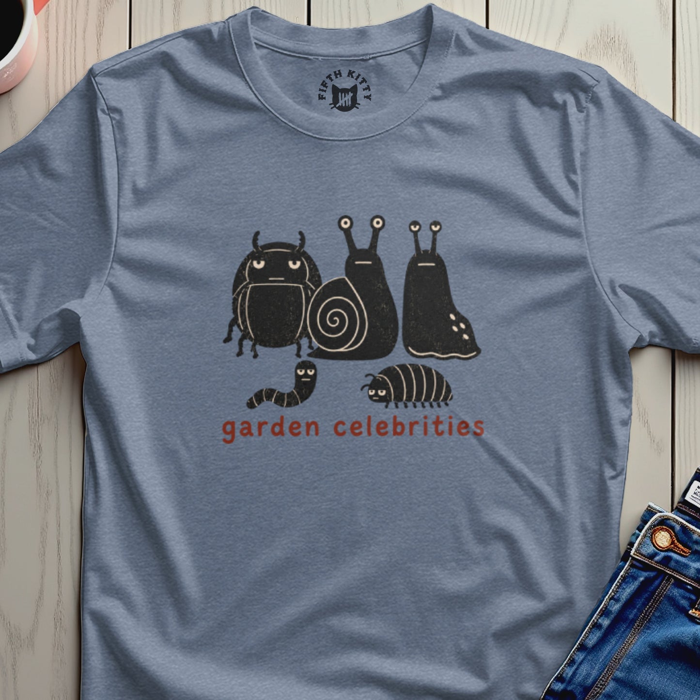 Blue t-shirt with black cartoon insects and red text "garden celebrities."