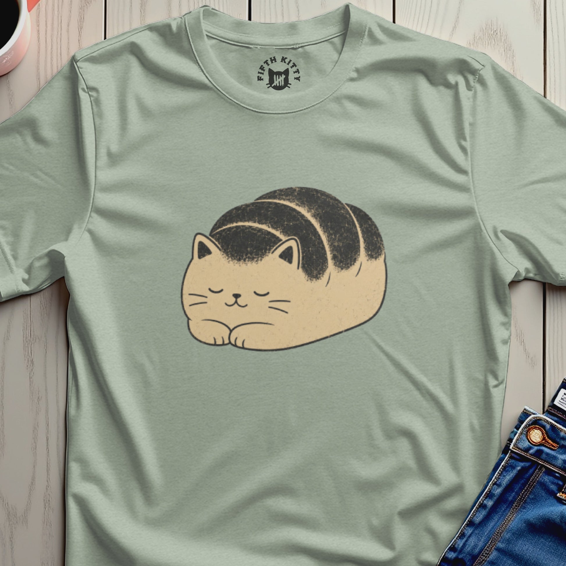 Cute cat loaf illustration with "Fifth Kitty" logo on a light green t-shirt.